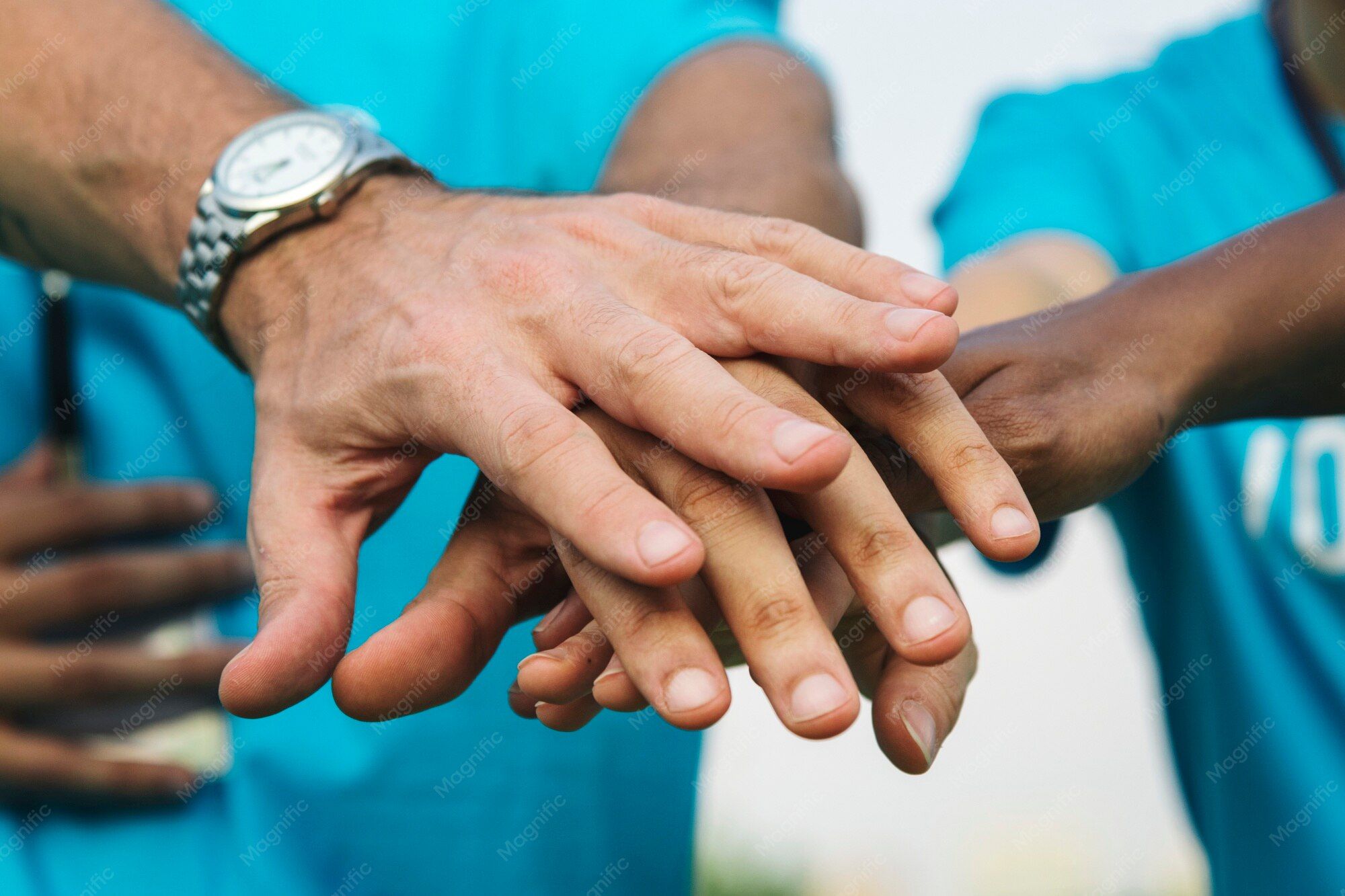 Volunteers stacking their hands together